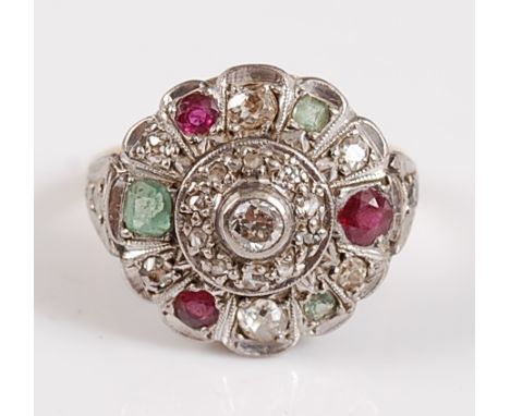 An 18ct and platinum diamond, ruby and emerald circular cluster ring, the nineteen old European and rose cut diamonds measuri