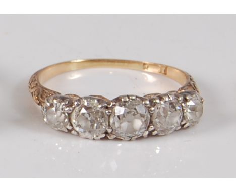 An Edwardian yellow and white metal diamond half hoop ring, comprising five graduated Old European cut diamonds in claw setti