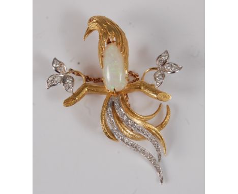 A contemporary yellow metal, opal and diamond set bird brooch, the bird perched upon a branch, having a cabochon opal set bod