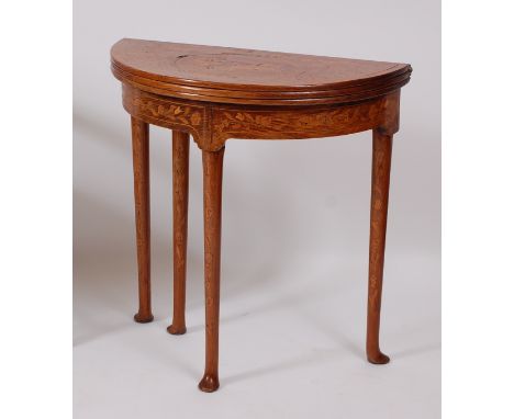 A walnut and marquetry inlaid demi-lune triple leaf games table, in the 18th century style, the top marquetry inlaid with a c