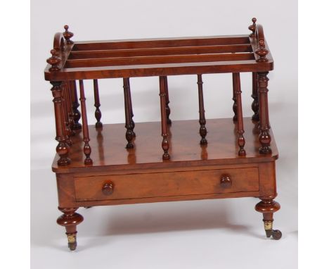 A mid-Victorian figured walnut three-division music canterbury, having end carry handles and turned finials, to further turne