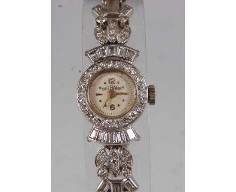 A lady's Delbana platinum cased and diamond set cocktail watch, having a signed champagne dial with numerals at 12 and 6 o'cl