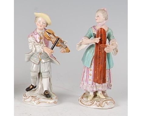 A near-pair of Meissen porcelain musician figures, him playing a violin and her playing a harp, each decorated in bright enam