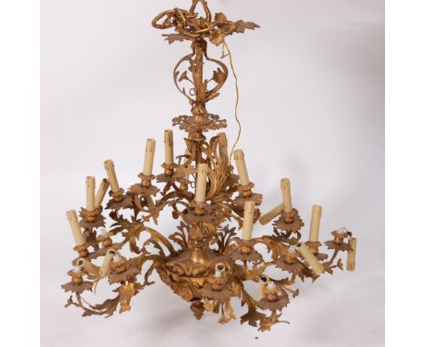 A Rococo style gilt metal 25-light electrolier, the centre column issuing five candle arms over a central boss further issuin
