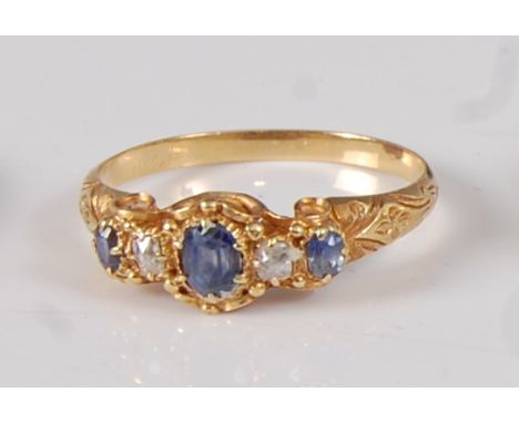 A late Victorian yellow metal, sapphire and diamond five stone half hoop ring, the three graduated oval sapphires measuring b