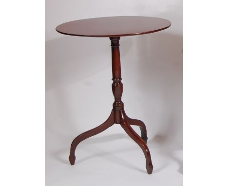 An early 19th century mahogany tilt-top pedestal tripod table, raised on turned column to umbrella legs, h.72cm, w.55.5cm, d.