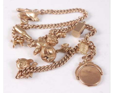 A 9ct yellow gold Albert curblink chain, with swivel clasp and bolt ring, fitted with eleven charms to include a swan, poodle