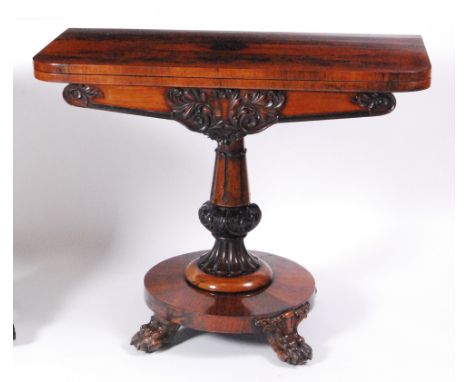 An early Victorian rosewood pedestal card table, having a fold-over top with swivel action to a turned, knopped and fluted co