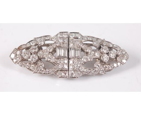 A white metal oblong Art Deco style diamond panel brooch, featuring a centre section of four baguette cut diamonds with an op