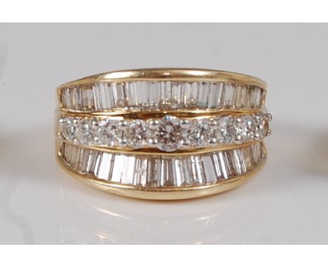 A contemporary 14ct gold diamond dress ring, arranged as a centre row of nine four-claw set brilliants, each weighing approx 