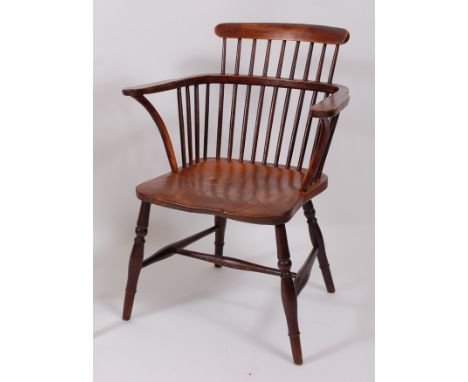 A circa 1840 Thames Valley elm seat and ash comb-back Windsor chair, raised on turned supports united by H stretcher.Stands w