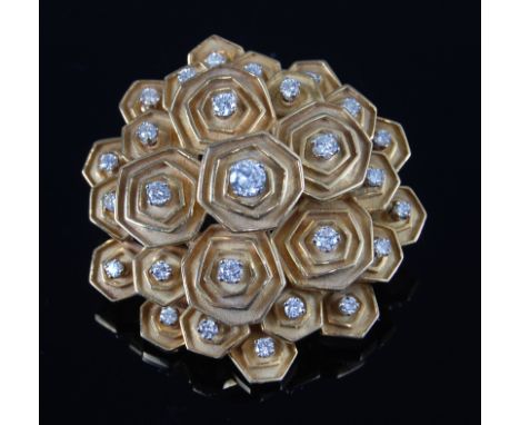 An 18 carat gold and diamond set brooch by Boucheron, the raised and shaped panels of stepped graduating form, each set with 