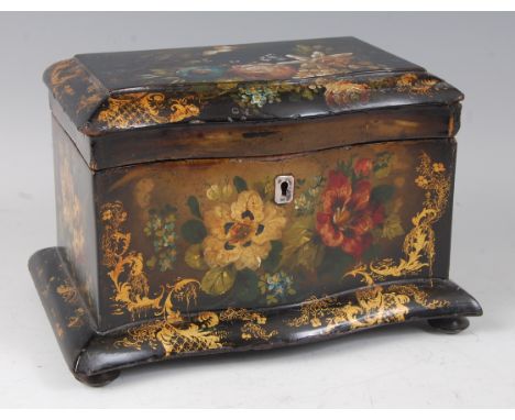 A Victorian papier-mâché and black lacquered tea caddy, having a serpentine front, decorated with floral sprays and heightene