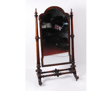 An early Victorian mahogany framed cheval mirror, the three quarter length mirror having a shaped plate within a moulded surr