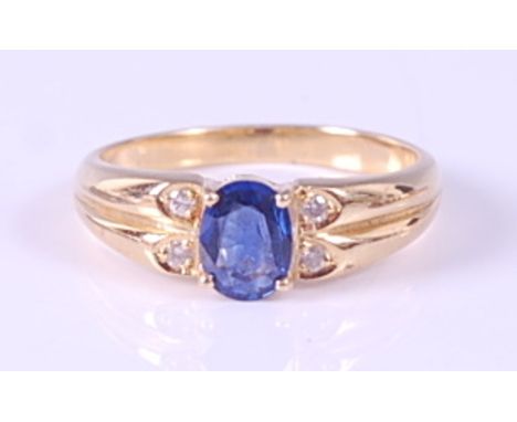 A yellow metal, sapphire and diamond dress ring, comprising an oval faceted sapphire in a four claw setting with double shoul