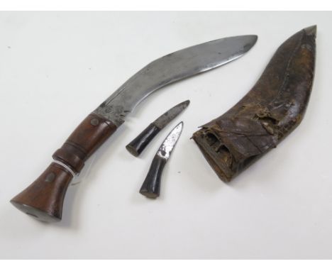Kukri: A good quality working (not tourist) Kukri. Polished wood grip, blade 12". With armourers mark 'THAUDSHS' ? Ricasso ma