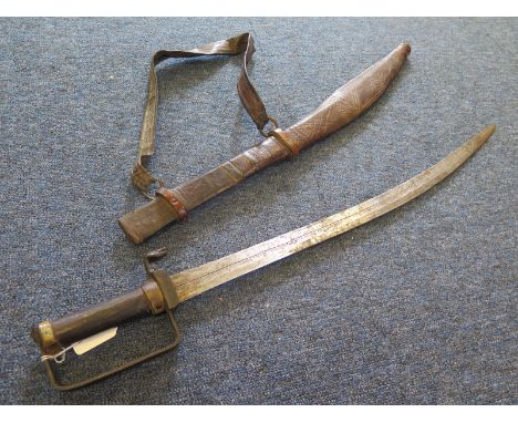 Sword: A good North African (?) sword. Cylindrical grip with square knucklebow and snake cobra quillon. Slightly curved blade