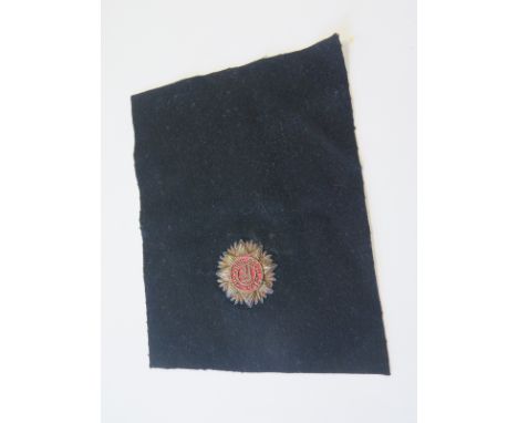 Irish Free State Army. Extremely scarce early 1920s embroidered badge with Fianna Fail crest, still on its original, uncut, b