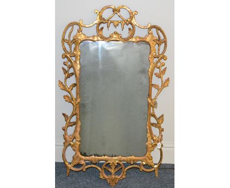 An English Carved and Gilded Pier Glass, circa 1760, the rectangular plate within a rockwork and acanthus scroll rococo style