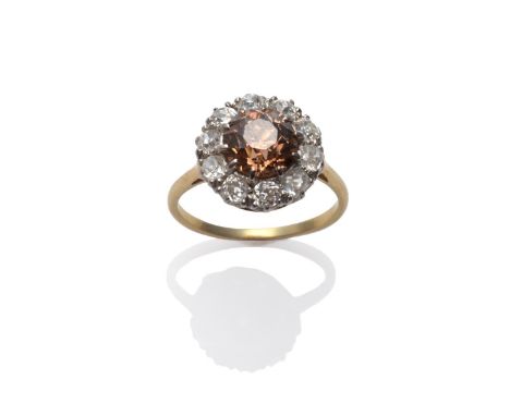 A Brown and White Diamond Cluster Ring, an old cut brown diamond within a border of old cut white diamonds, in white claw set