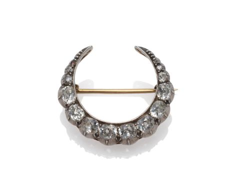 A Victorian Diamond Crescent Brooch, set with graduated old cut diamonds in white collet settings, total estimated diamond we