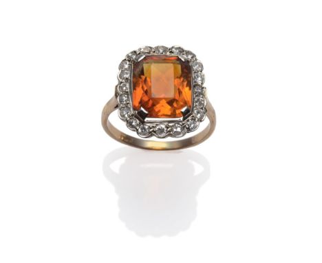 A Citrine and Diamond Cluster Ring, an octagonal brilliant cut citrine within a border of eight-cut diamonds, in white collet