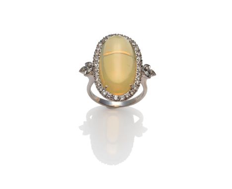 An 18 Carat White Gold Opal and Diamond Cluster Ring, an oval cabochon opal within a border of round brilliant cut diamonds, 