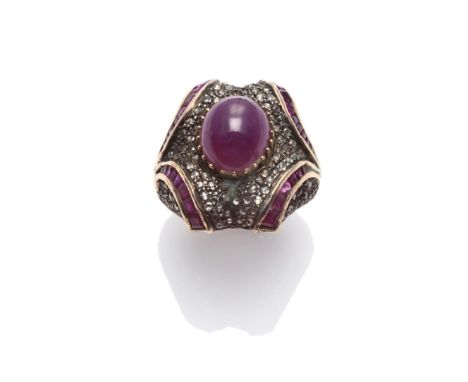 An Indian Ruby and Diamond Ring, a cabochon ruby within a chunky frame set with rose cut diamonds and calibré cut rubies, on 