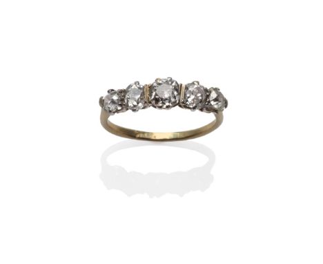 A Diamond Five Stone Ring, the graduated old mine cut diamonds in white claw settings, on a yellow tapered shoulder plain pol