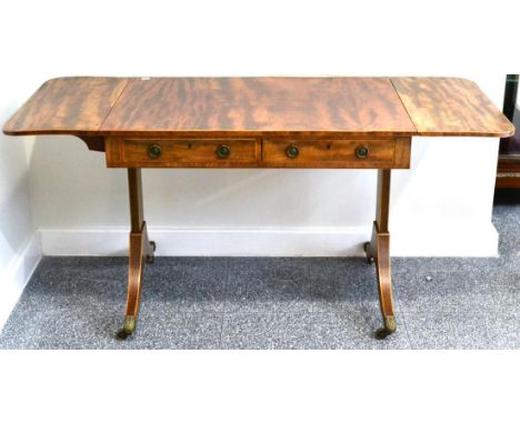 A Regency Mahogany and Boxwood Strung Sofa Table, early 19th century, with rounded drop leaves, one real and one sham drawer 