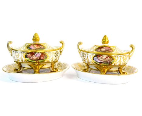 A Pair of English Porcelain Sauce Tureens, Covers and Stands, circa 1810, of urn shape with scroll handles on four leaf feet,