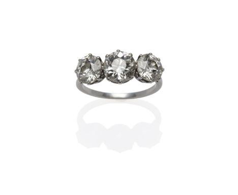 A Diamond Three Stone Ring, circa 1910, the graduated old cut diamonds in white claw settings, to a plain polished shank, tot