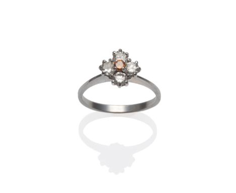 A Diamond Cluster Ring, an orangey-brown round brilliant cut diamond within a frame of four white round brilliant cut diamond