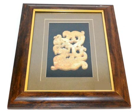 A Chinese Jade Type Plaque, in Archaic style, as a dragon amongst foliage and scroll work, 14cm by 10cm, framed Some surface 