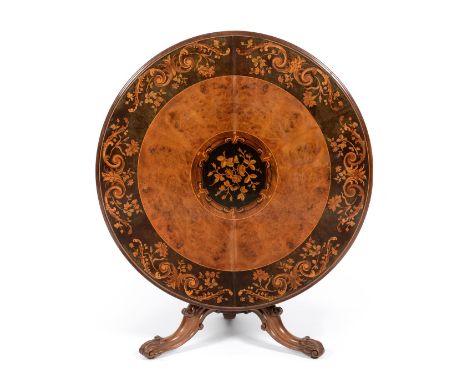 An Early Victorian Burr Walnut, Ebony and Floral Marquetry Centre Table, circa 1850, the circular top richly inlaid, the bord