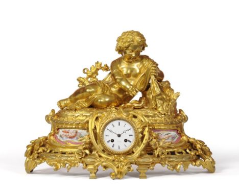 A Large Ormolu and Porcelain Striking Mantel Clock, signed Hry Marc, A Paris, circa 1880, reclining cherub appearing to be re