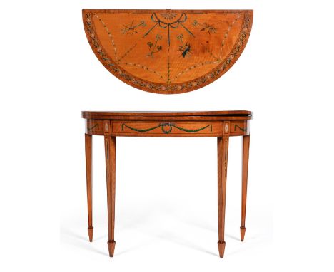 A George III Style Satinwood, Tulipwood Banded and Polychrome Decorated Foldover Card Table, richly decorated with trophies, 