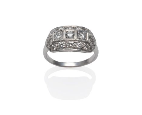 An Art Deco Style Diamond Cluster Ring, the pierced plaque form set with round brilliant cut diamonds, in white claw settings