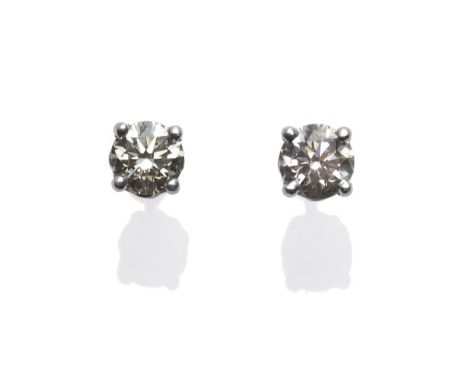 A Pair of Diamond Solitaire Earrings, round brilliant cut diamonds in white four claw settings, total estimated diamond weigh