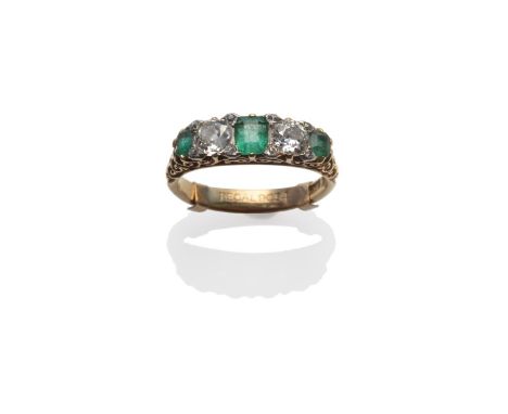 An Emerald and Diamond Five Stone Ring, the step cut emeralds alternate with old cut diamonds, with pairs of tiny rose cut di