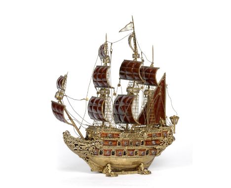 A Continental Silver Gilt, Enamel and Gem Set Nef, 20th century, the triple deck man-o-war in full sail with two lower gun de