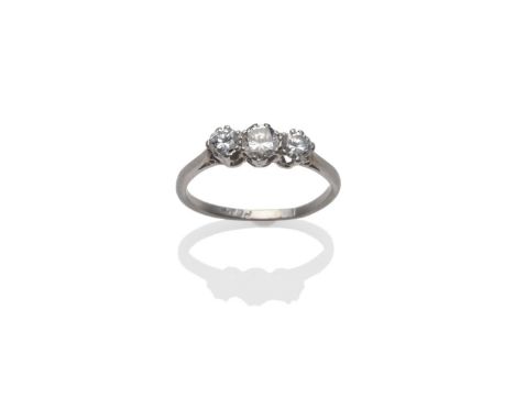 A Diamond Three Stone Ring, the graduated round brilliant cut diamonds in a white claw setting, to a tapered shoulder plain p