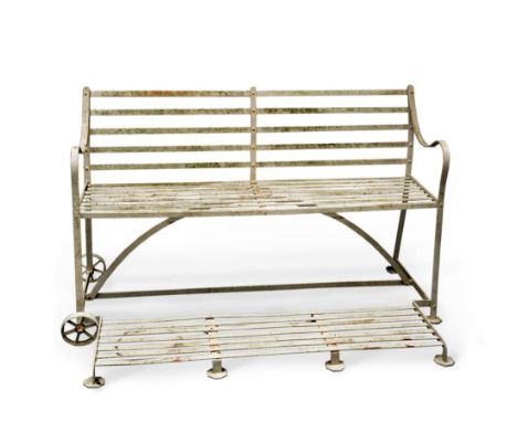 A Regency Wrought Iron Garden Bench, with slatted back and seat, scroll arm supports and slatted hinged foot rest, 155cm wide