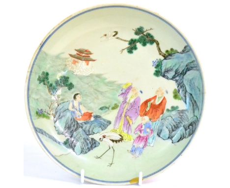 A Chinese Famille Rose Saucer Dish, 18th century, decorated in typical palette with figures and cranes within a stylised land