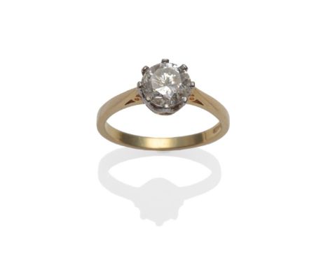 An 18 Carat Gold Diamond Solitaire Ring, the round brilliant cut diamond in a white claw setting on a yellow tapered shoulder