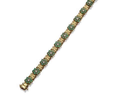 A Diamond and Emerald Bracelet, thirteen clusters of a round brilliant cut diamond in a white illusion setting, within a bord