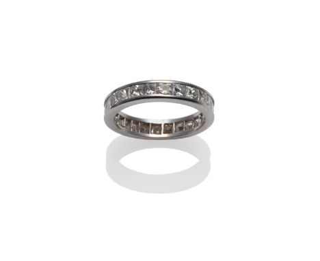 A Diamond Eternity Ring, princess cut diamonds in a white channel setting, total estimated diamond weight 2.80 carat approxim