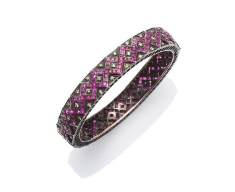 An Indian Ruby and Diamond Bracelet, calibré cut rubies channel set in a geometric design, with round cut diamond details  Th