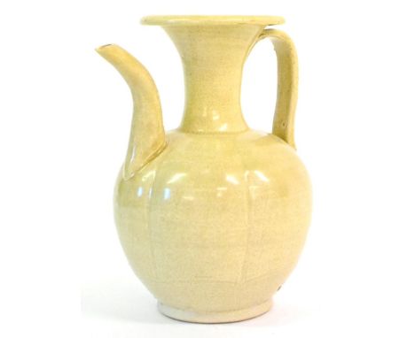 A Chinese Celadon Ewer, possibly Song Dynasty, of melon fluted ovoid form with flared neck and scroll spout, pale blue glaze,