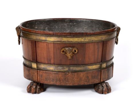 A Mahogany and Brass Bound Oval Wine Cooler, circa 1800, the body of staved construction with Rams head mask mounts and loop 
